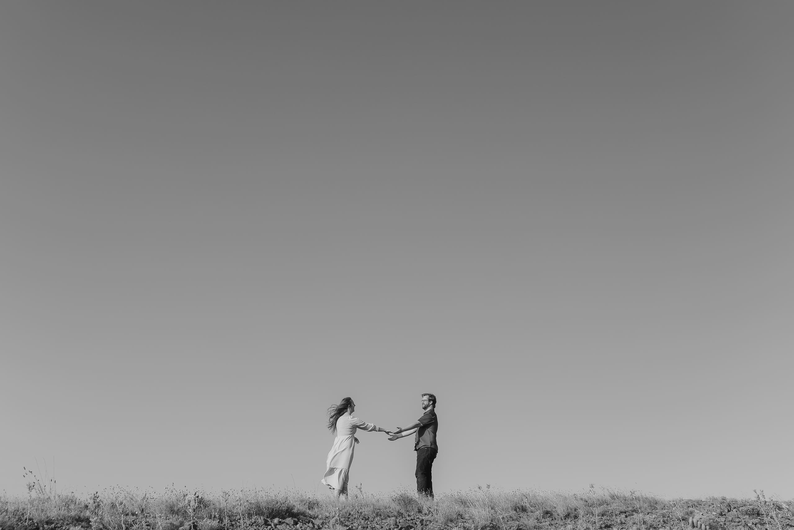 Reaching for each other’s hands on the ridgeline, sky wide above