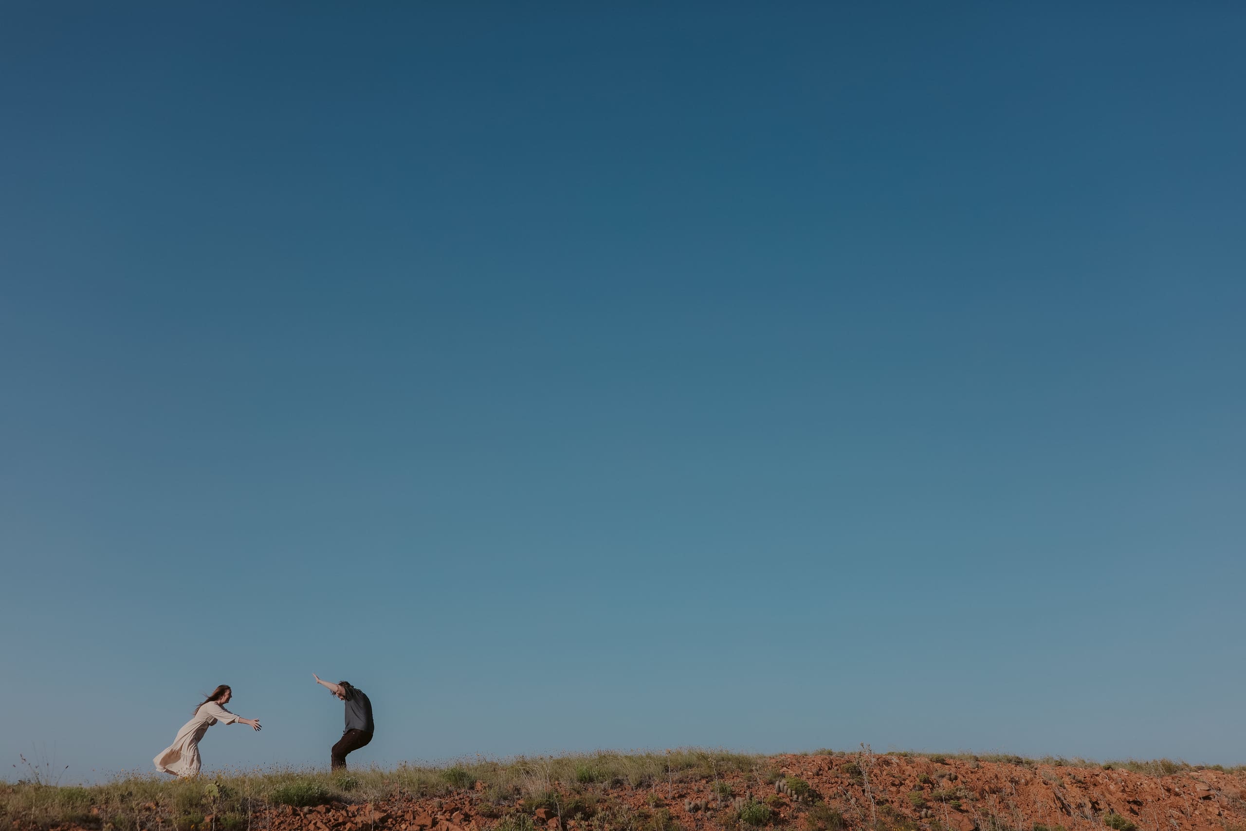 Reaching for each other on the ridgeline, sky stretching above
