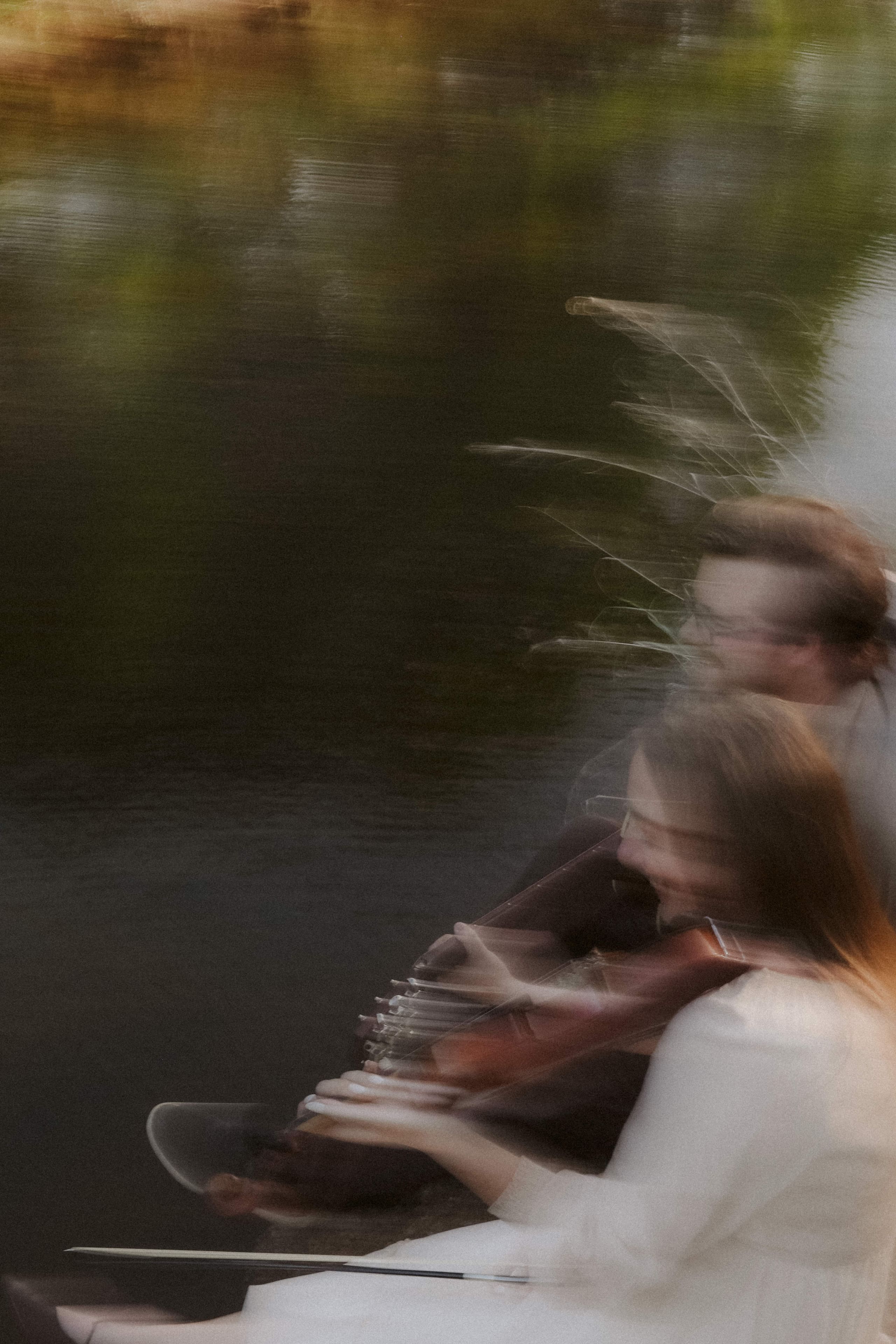 Soft motion blur of the couple playing together at the water’s edge