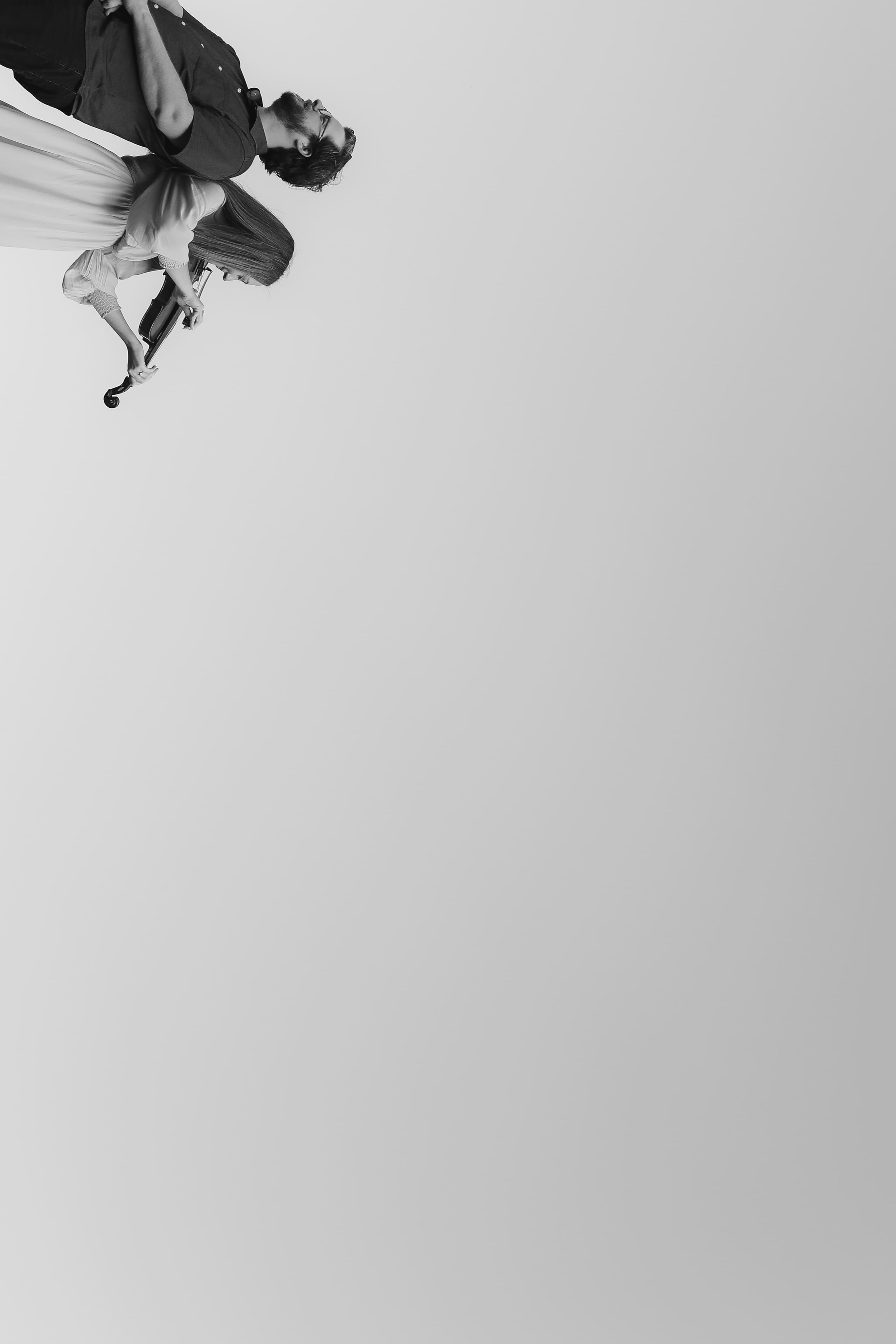 Violin and open sky in a tilted black-and-white frame