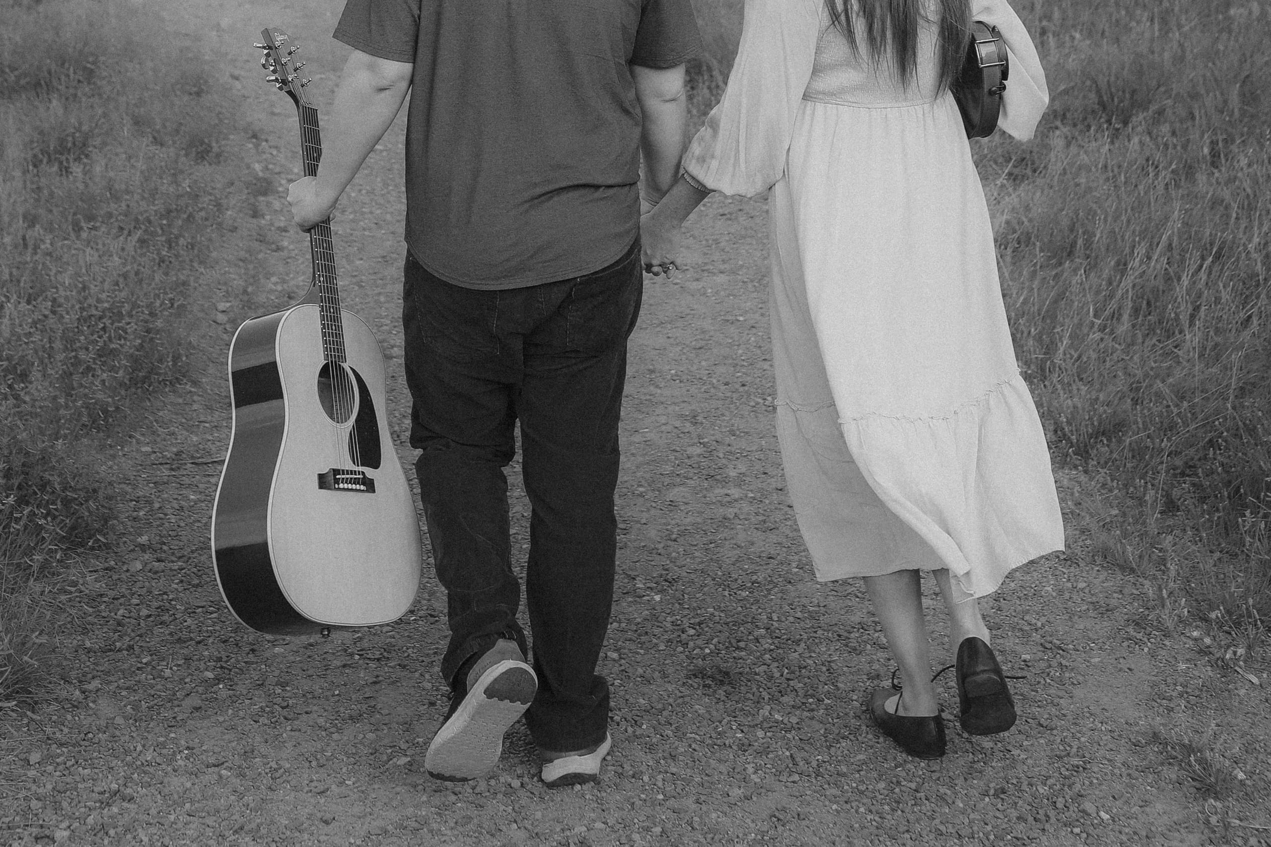 Walking the gravel path hand in hand, guitar and violin carried along