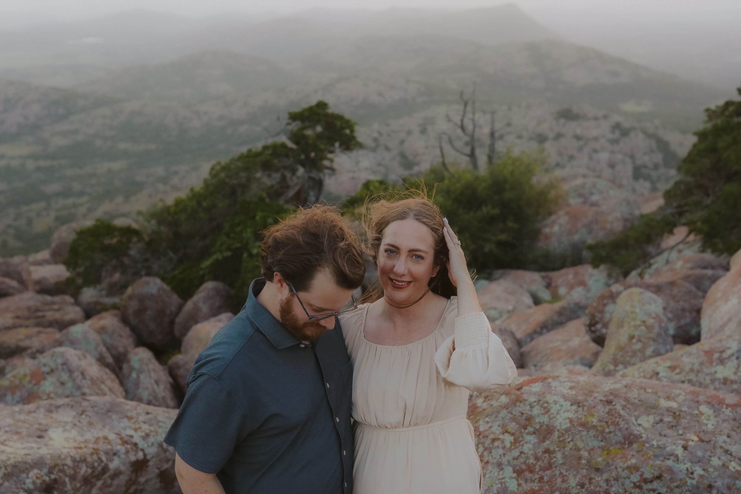 A smile toward the camera among the lichen-covered summit rocks