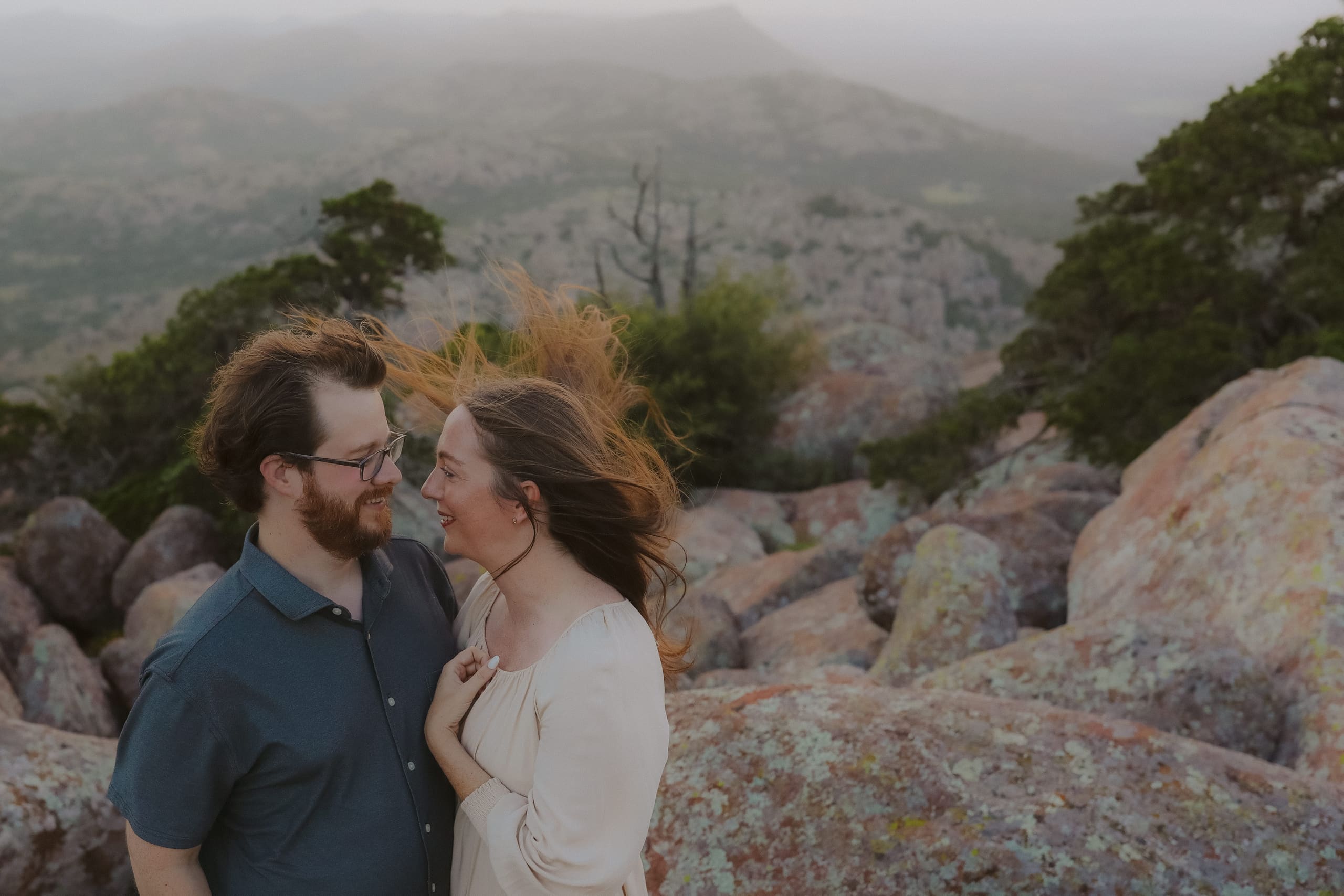 Face to face on the granite summit, her hair swept up by the wind