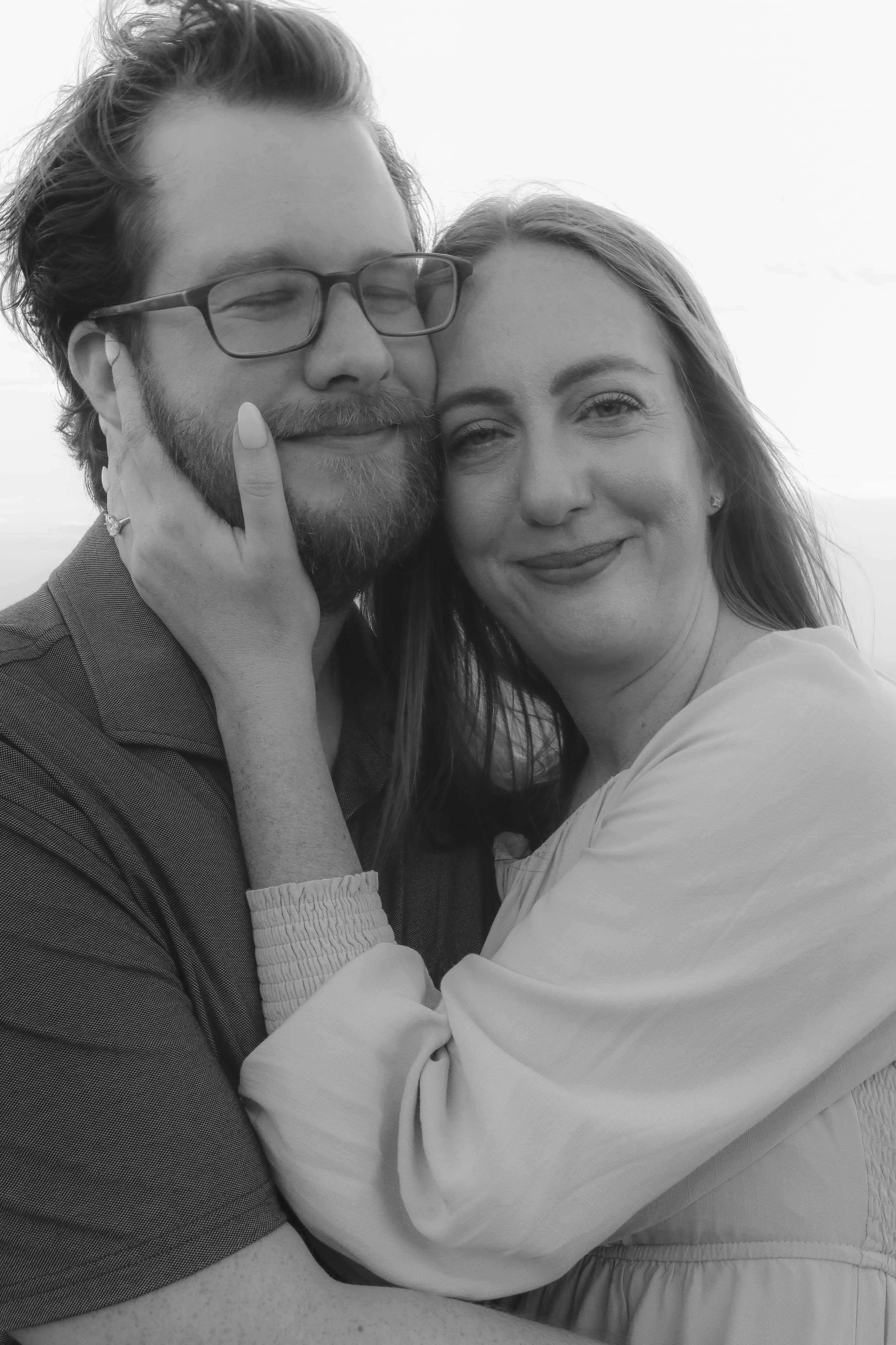 Noses touching, eyes closed, smiles just beginning