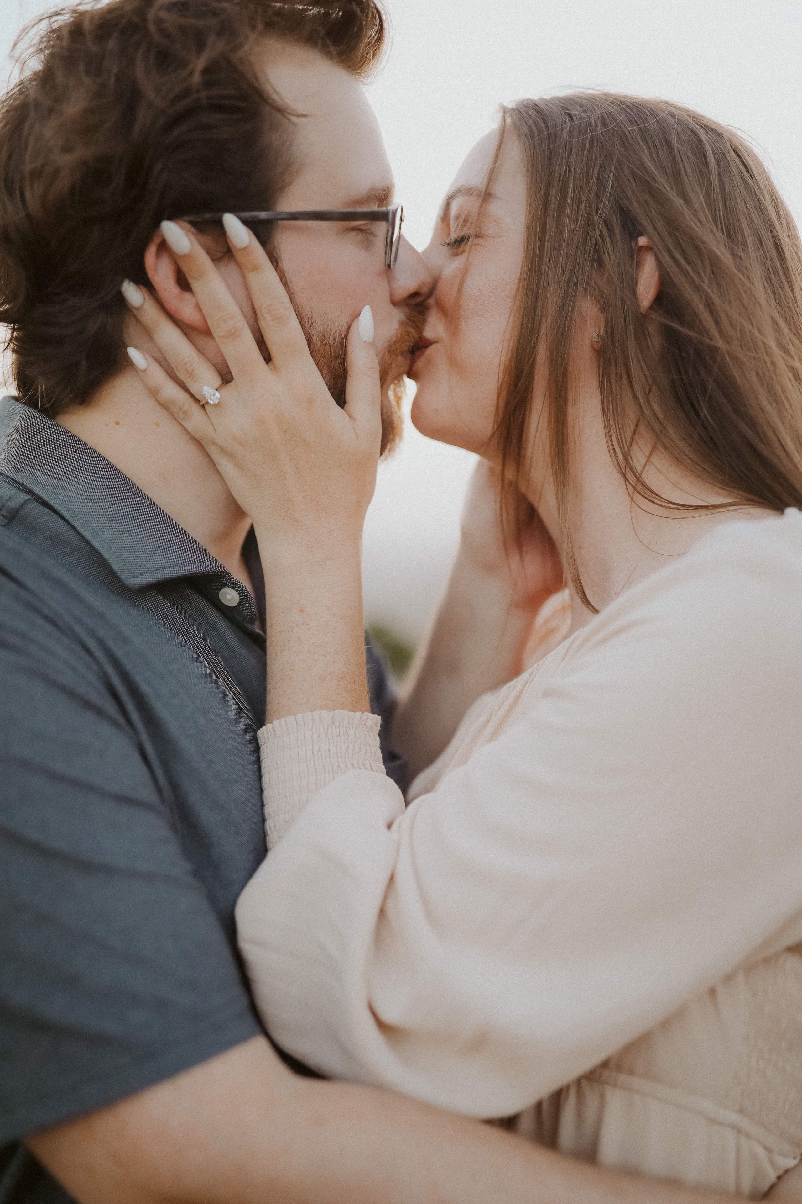 A kiss in the evening light, her hands holding his face