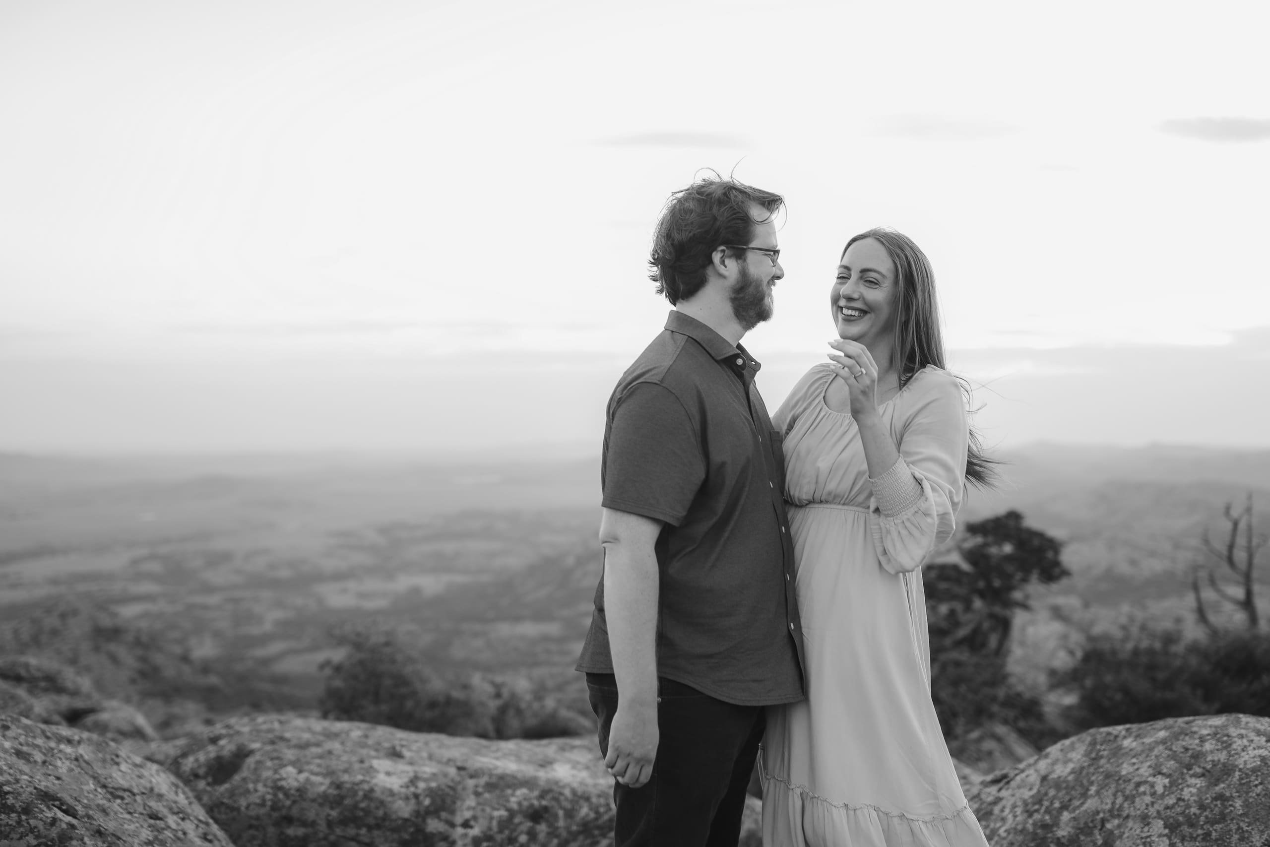 Laughing together on the summit in black and white