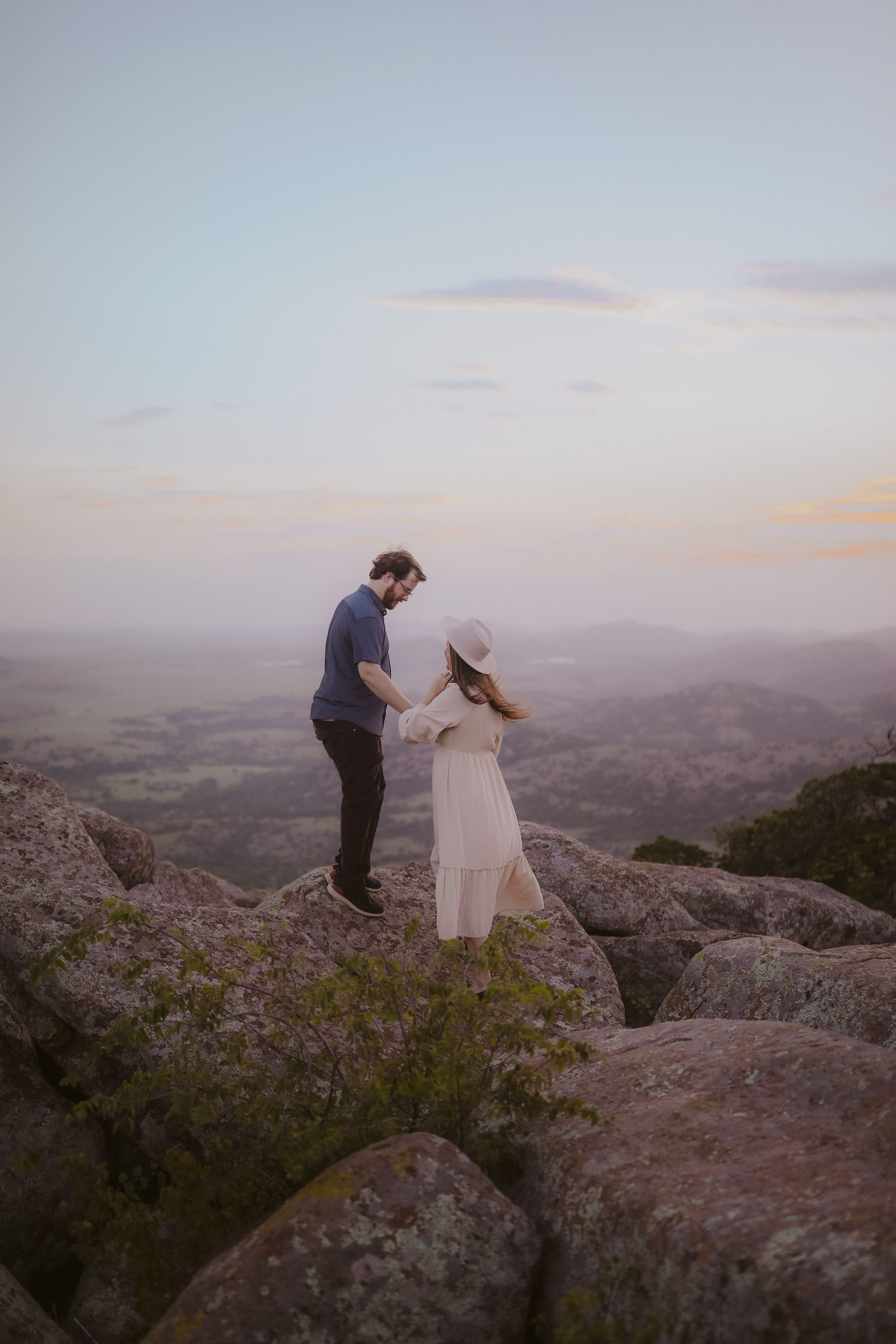 Facing each other on the mountaintop, valley haze stretching behind
