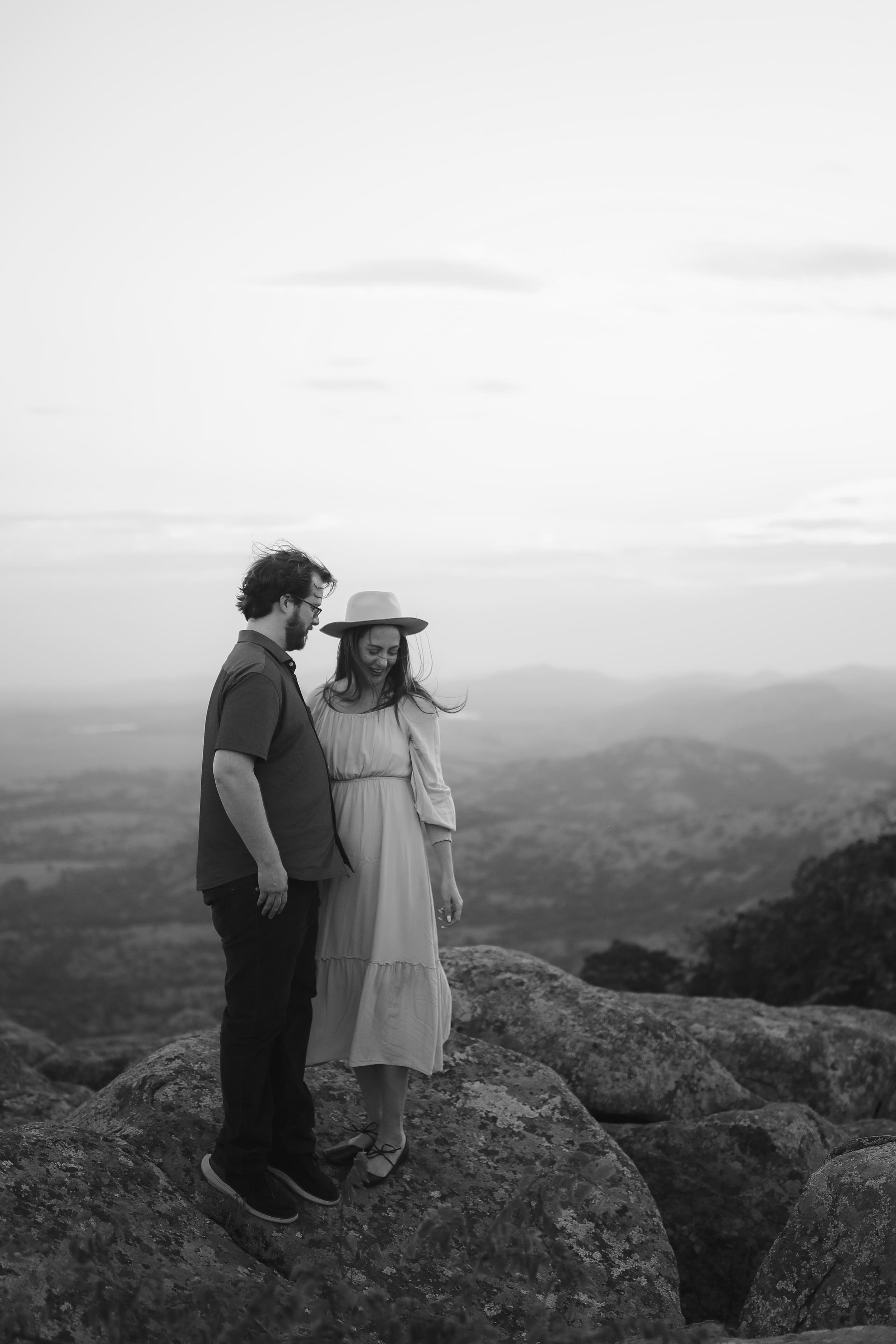 A quiet moment on the summit in black and white, hills fading below