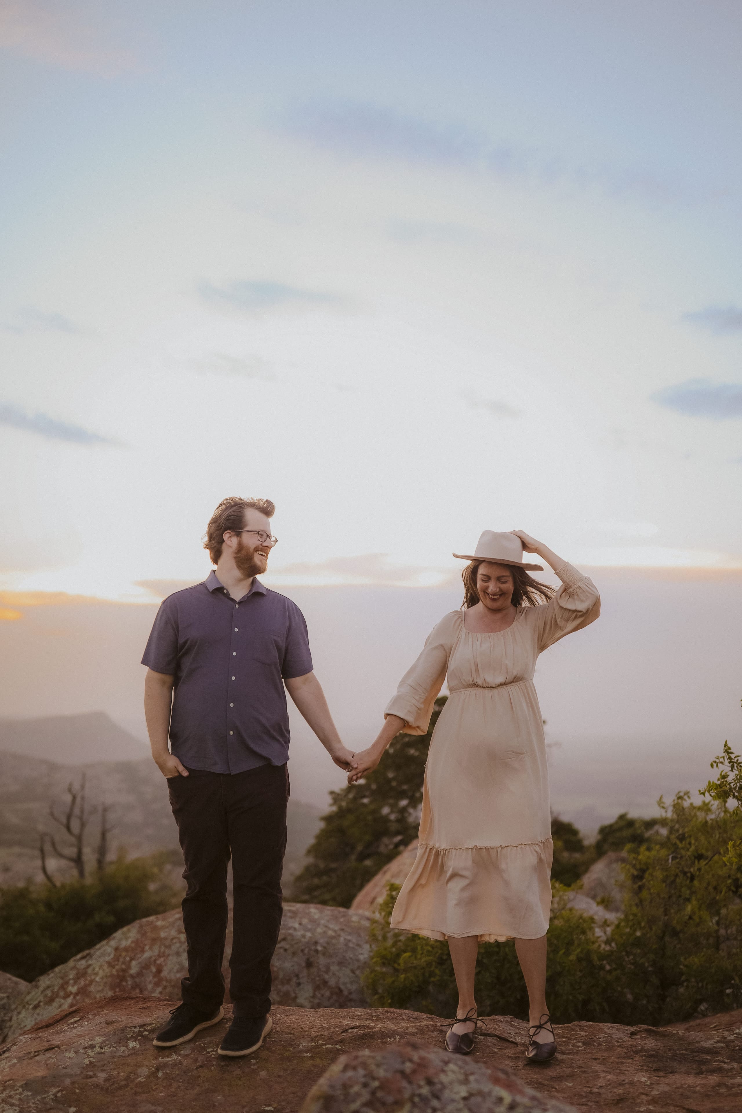 Hand in hand on the mountaintop at golden hour