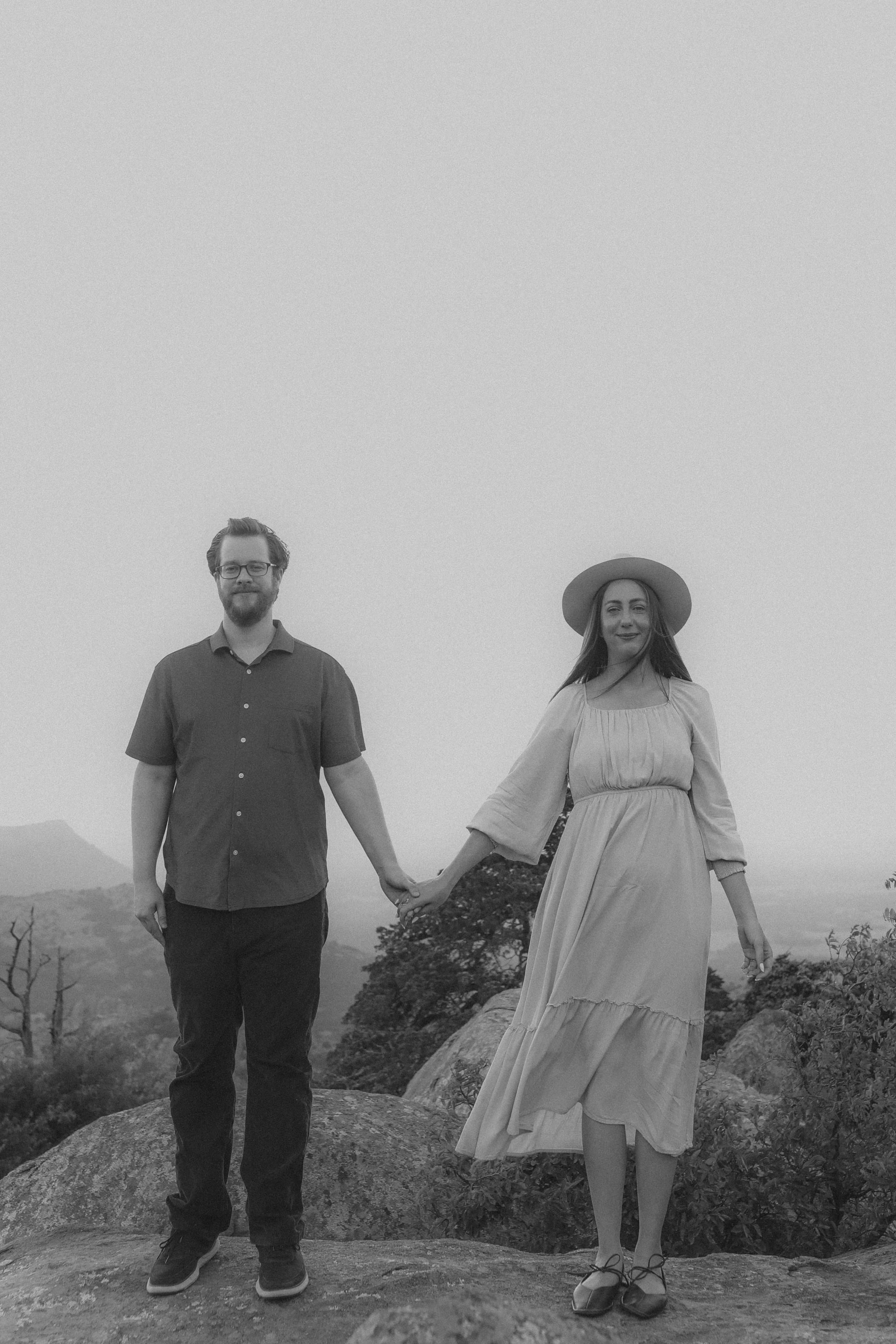 Hand in hand on the summit in black and white
