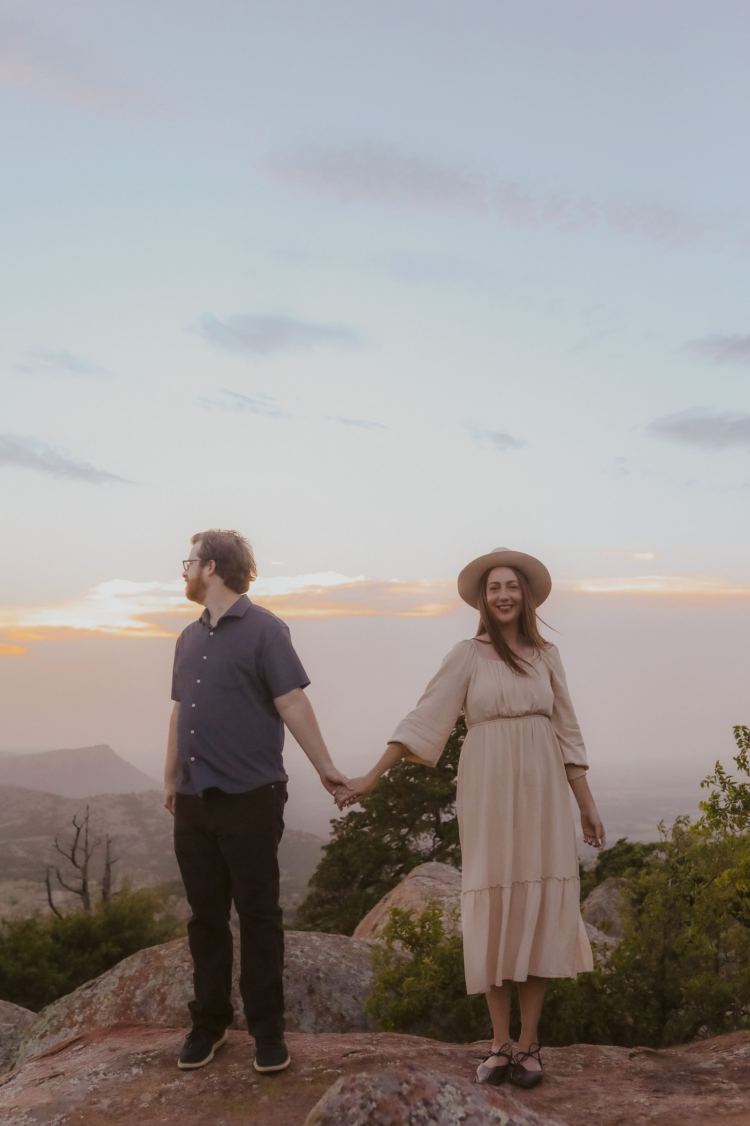 Holding hands at golden hour, her smile toward the camera