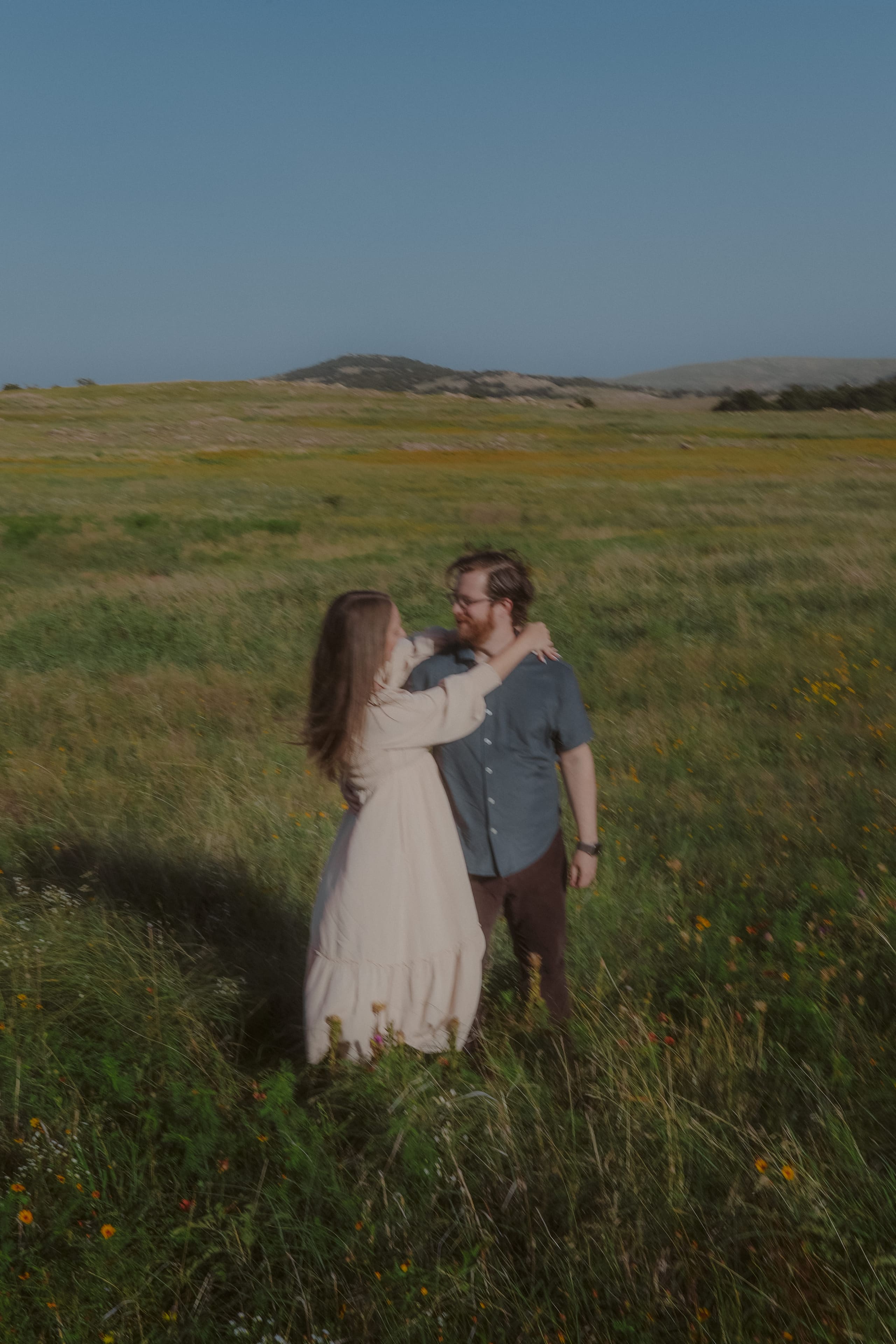 A soft, motion-blurred embrace in the wildflower meadow