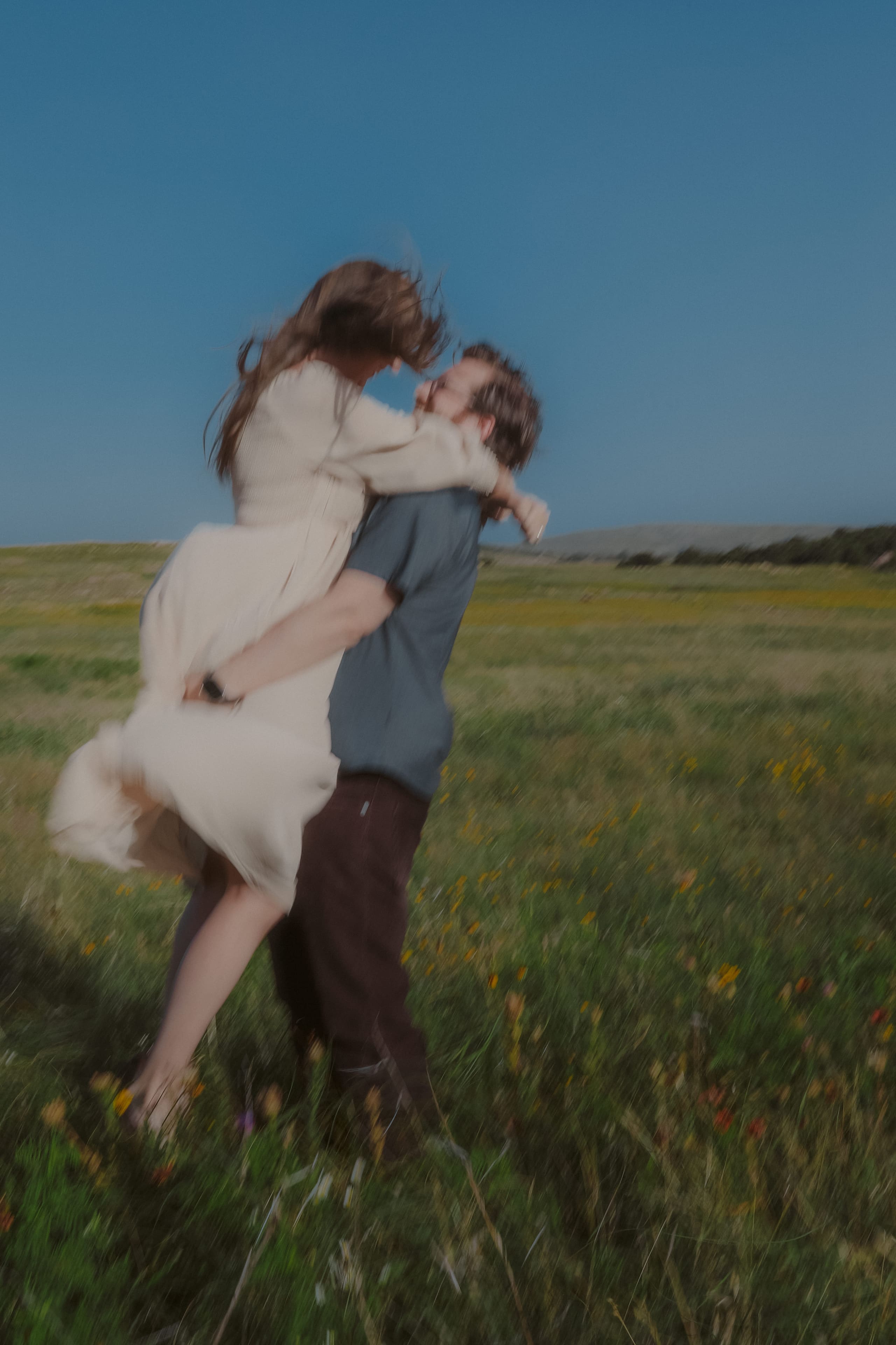 A blur of motion — swept off her feet in the wildflower field