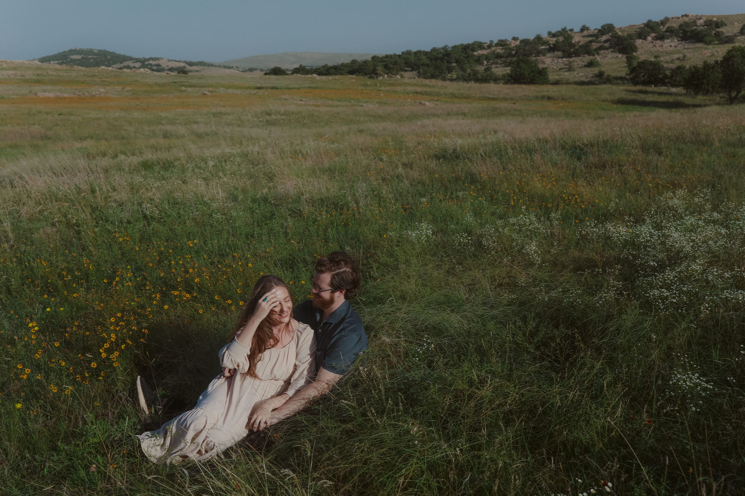 Tucked into the grass together, yellow wildflowers blooming at their side