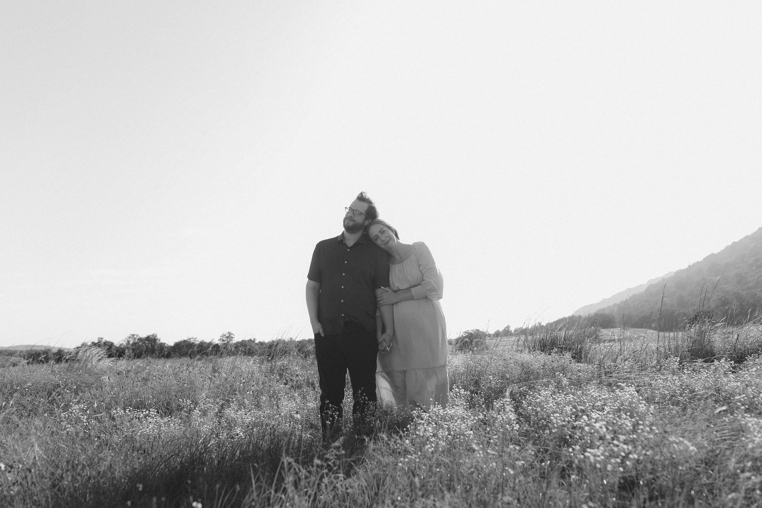 Her head on his shoulder among the wildflowers, in black and white