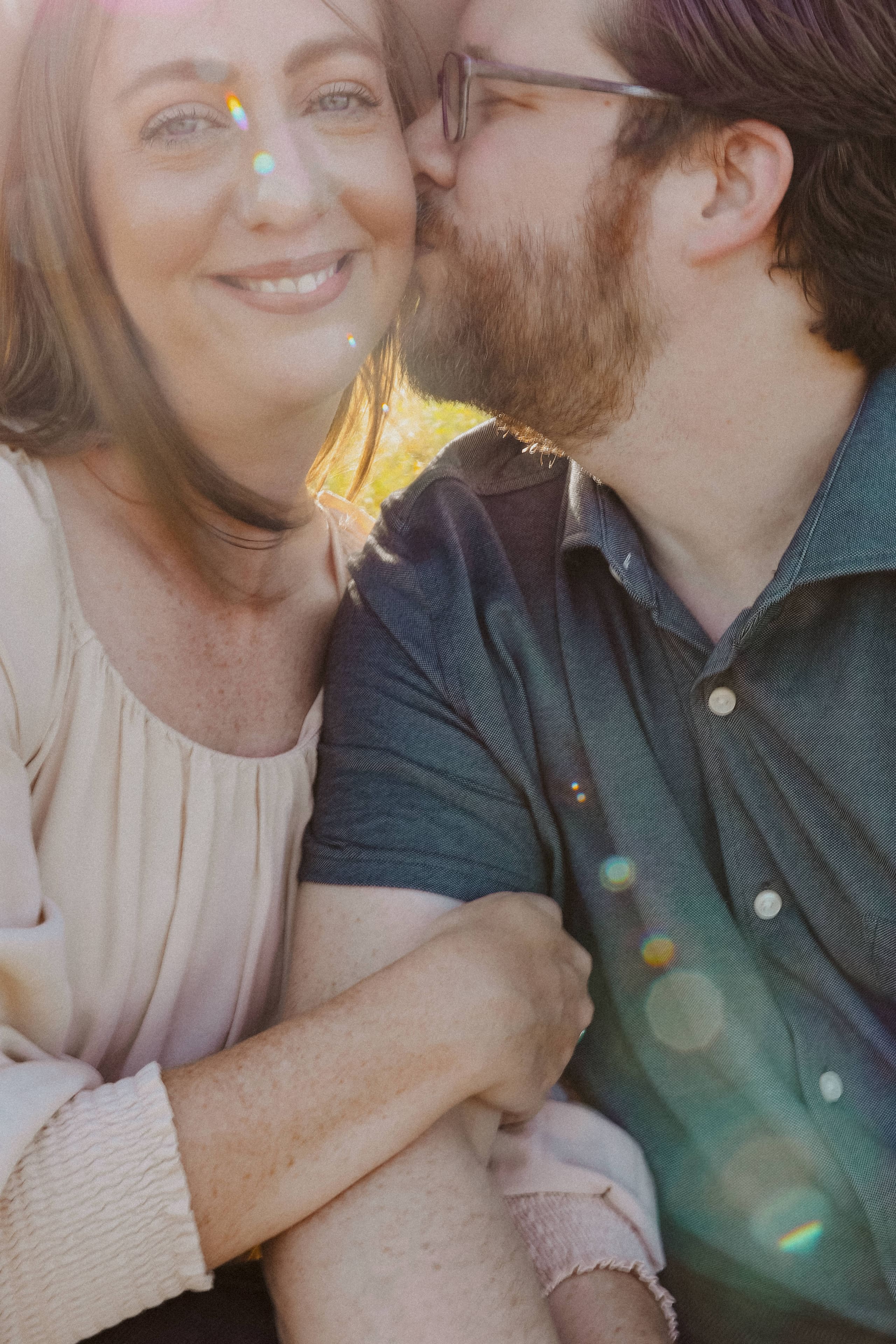 A kiss on the cheek, sunlight prisming across her smile